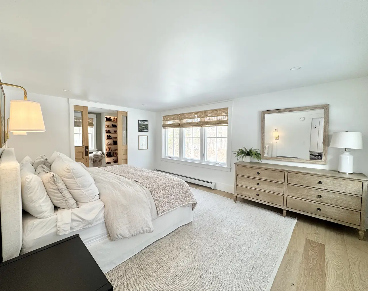 A serene primary bedroom in soft neutrals, styled with STELLAN pieces