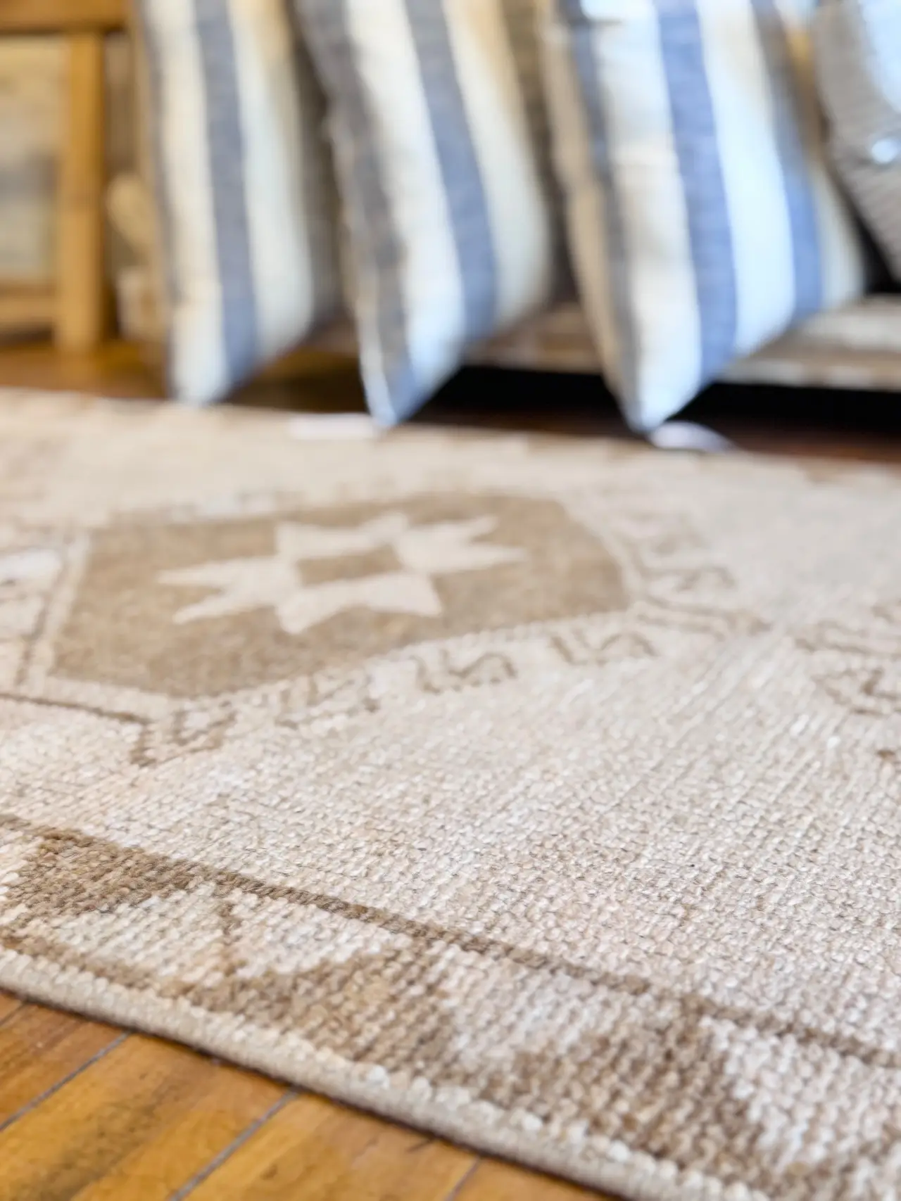 A star-medallion vintage rug layered with striped pillows