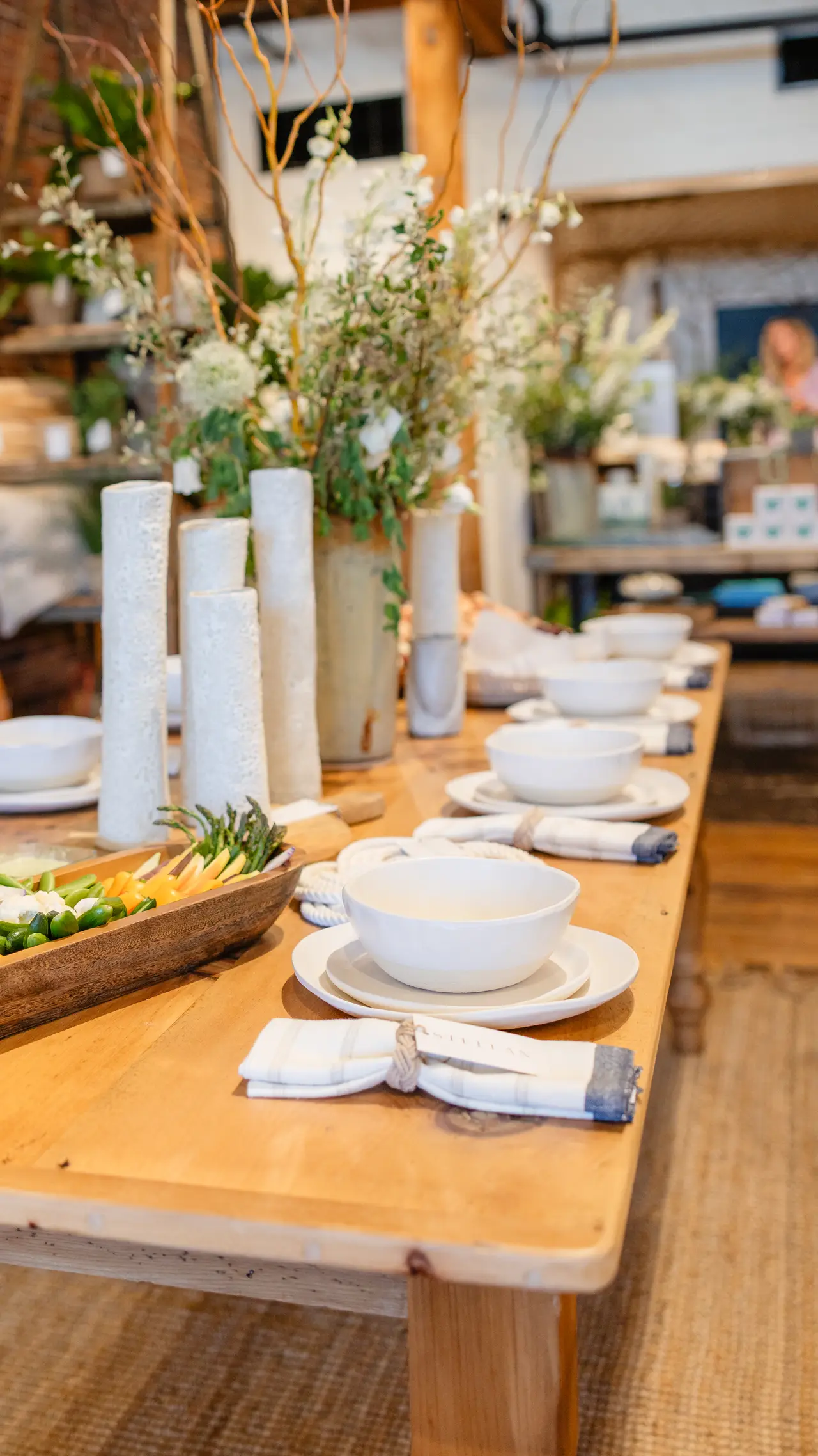 A long table styled with STELLAN ceramics, linens, and flowers