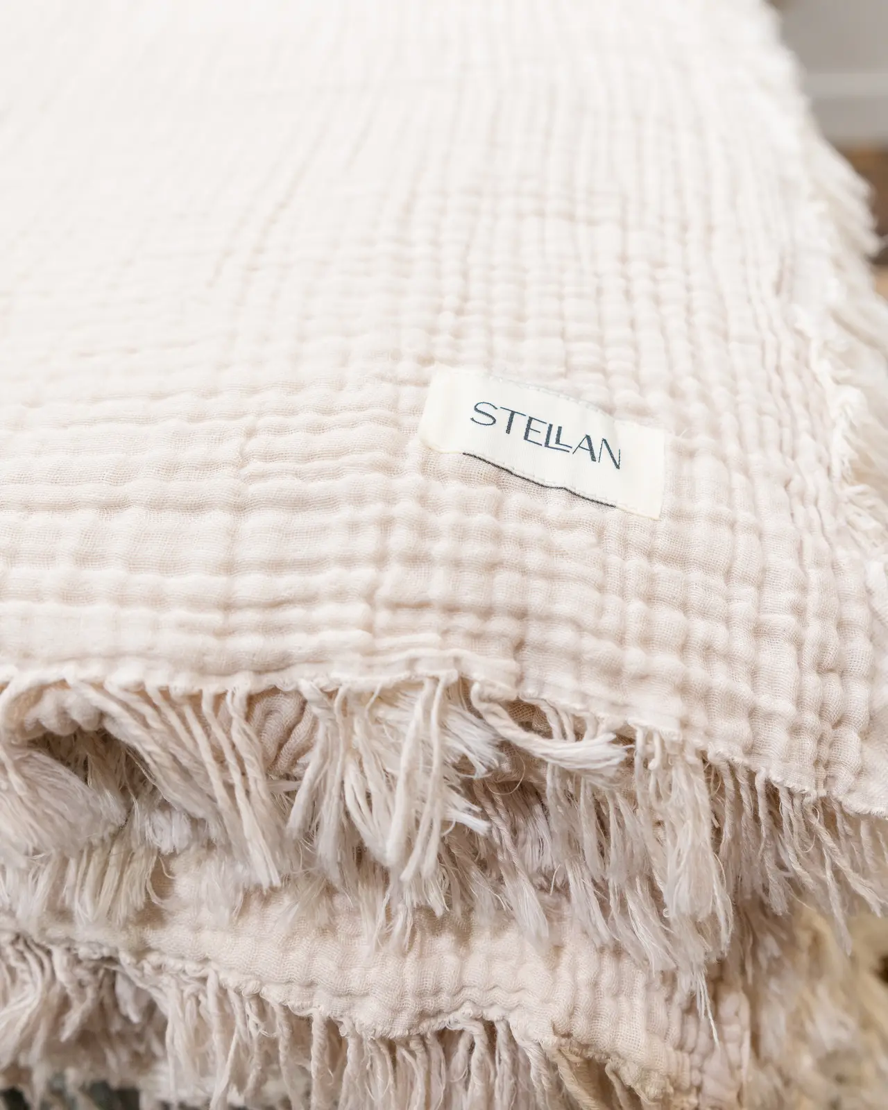A fringed STELLAN linen throw