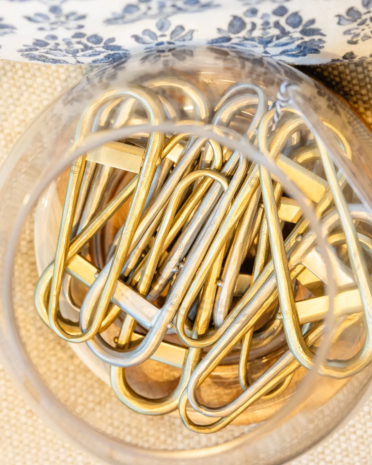 Brass and gold clips in a glass bowl