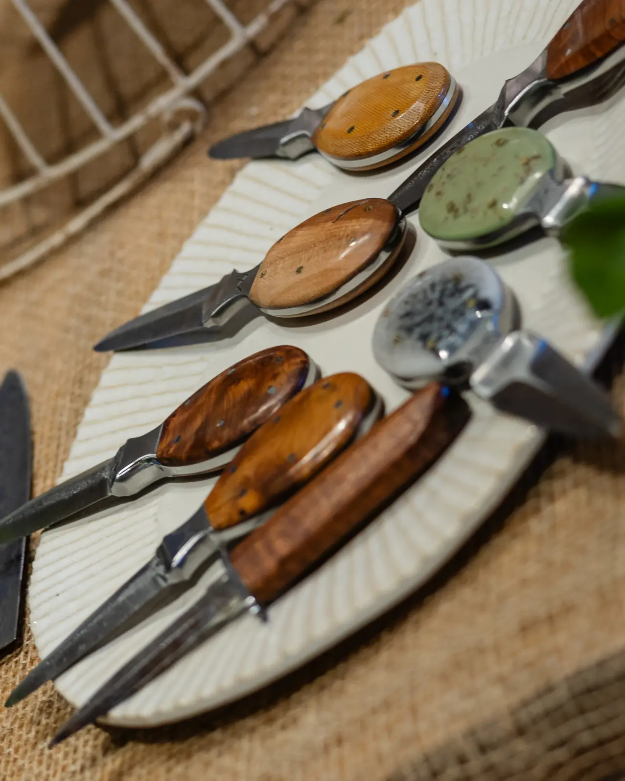 Wood-handled serving knives on a plate