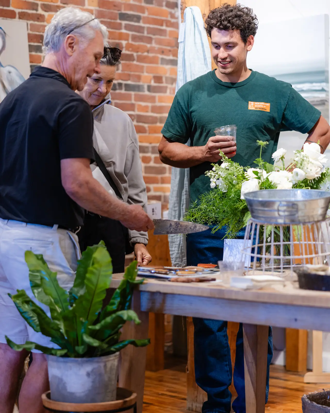 Guests and a maker gathered at a table