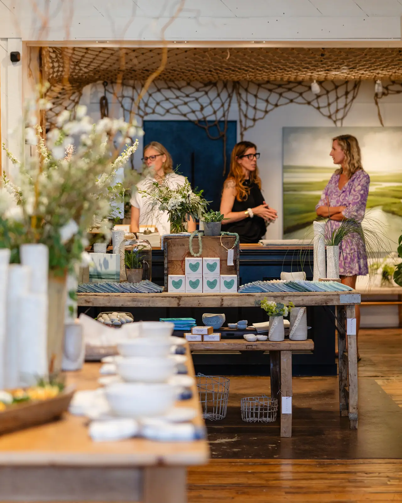 The shop floor during the opening, tables set with ceramics