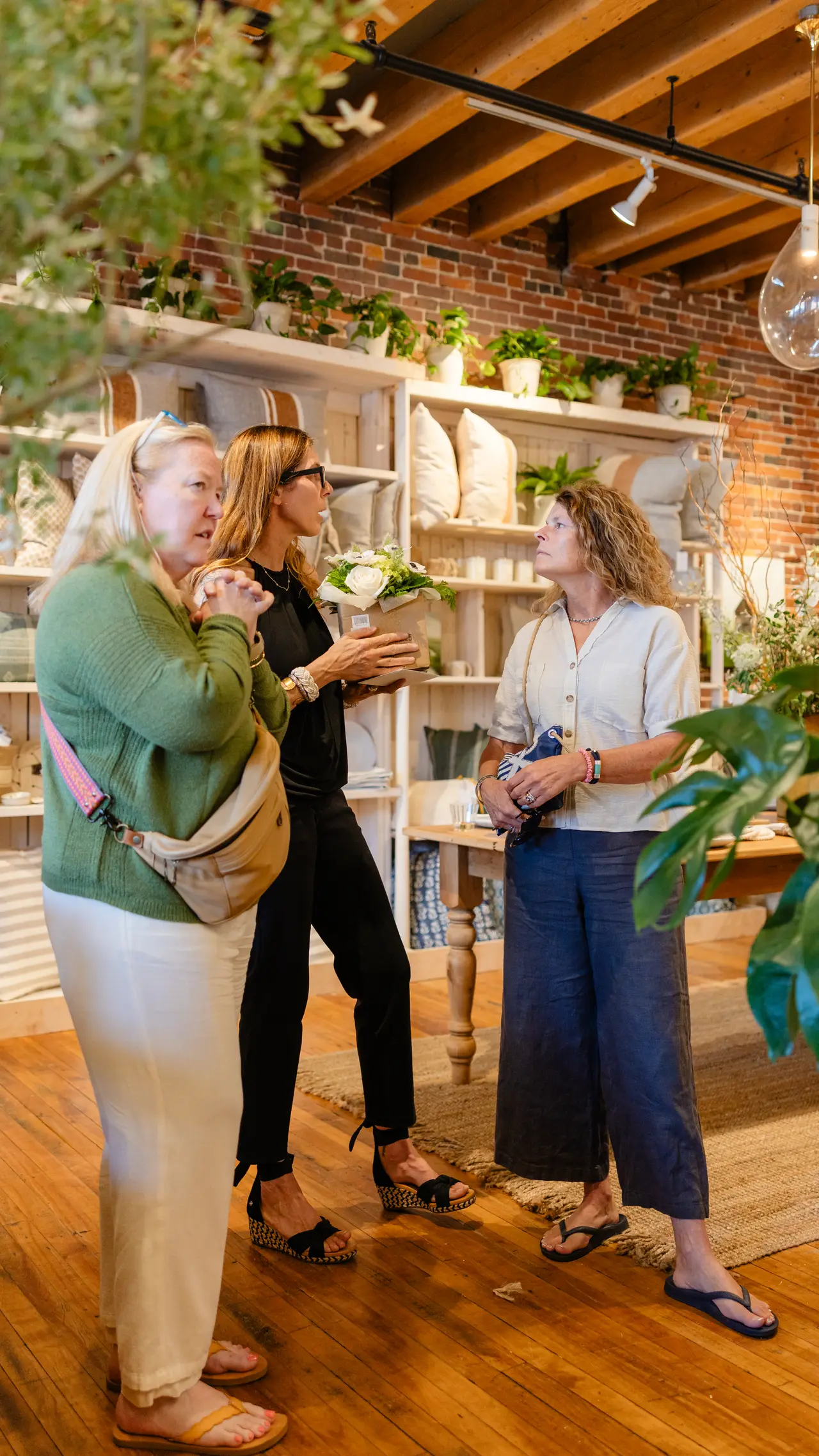 Guests talking among the plants and shelves